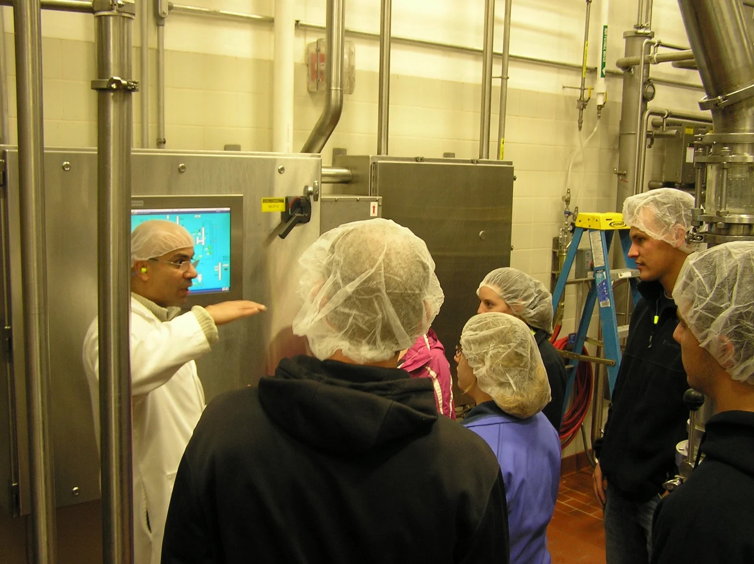 Dr. Hassan leading in-plant training at a dairy processing facility